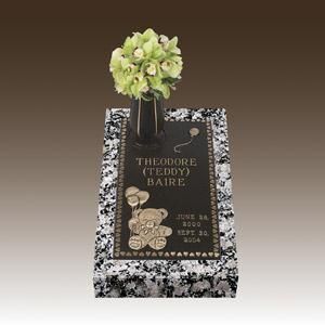 a gravestone with a vase of flowers on top of it .