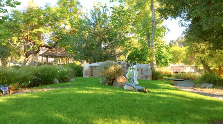 a skeleton is laying on the grass in a park .