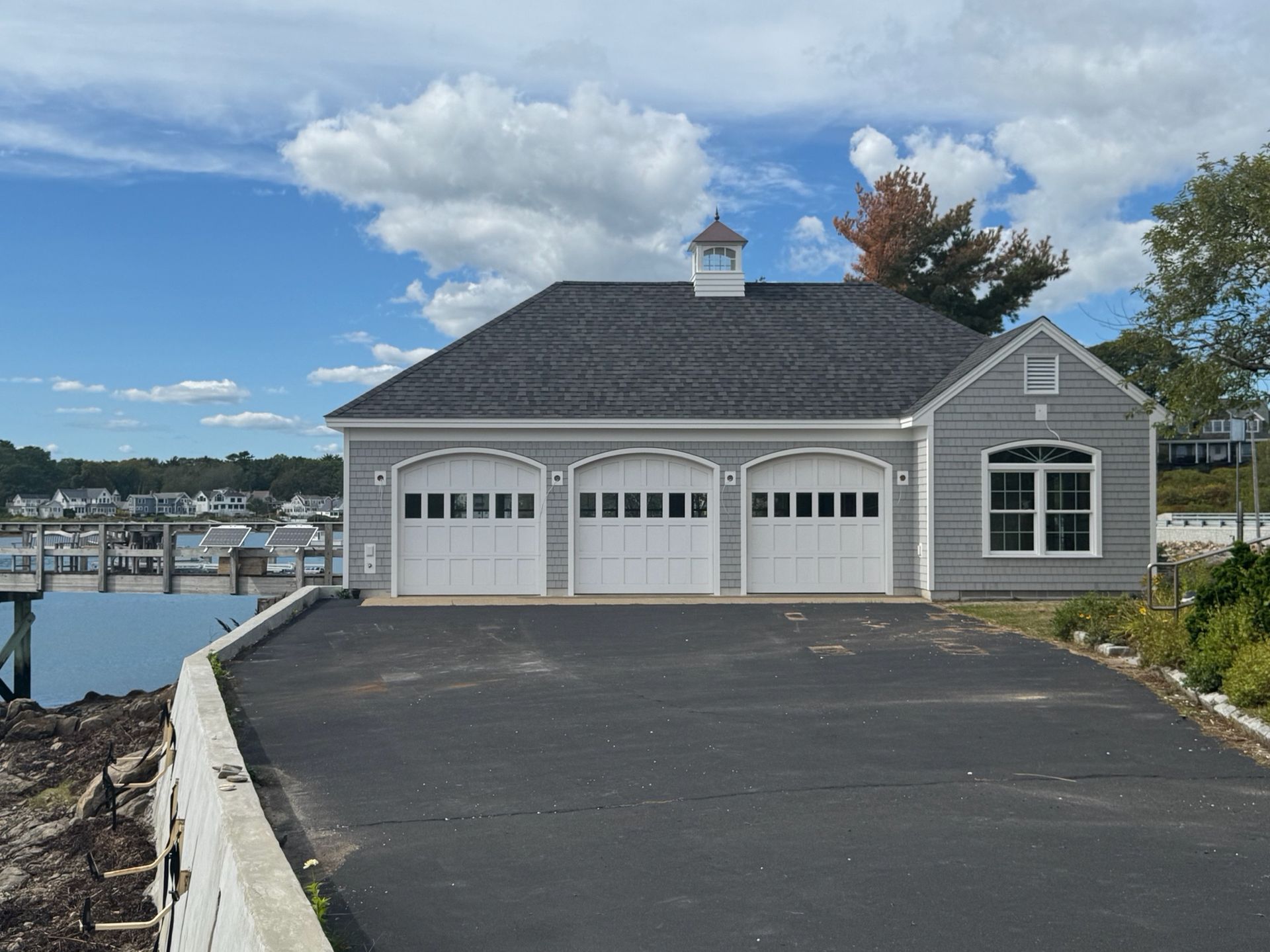 Two-story house with gray siding, white trim, and a small covered porch.