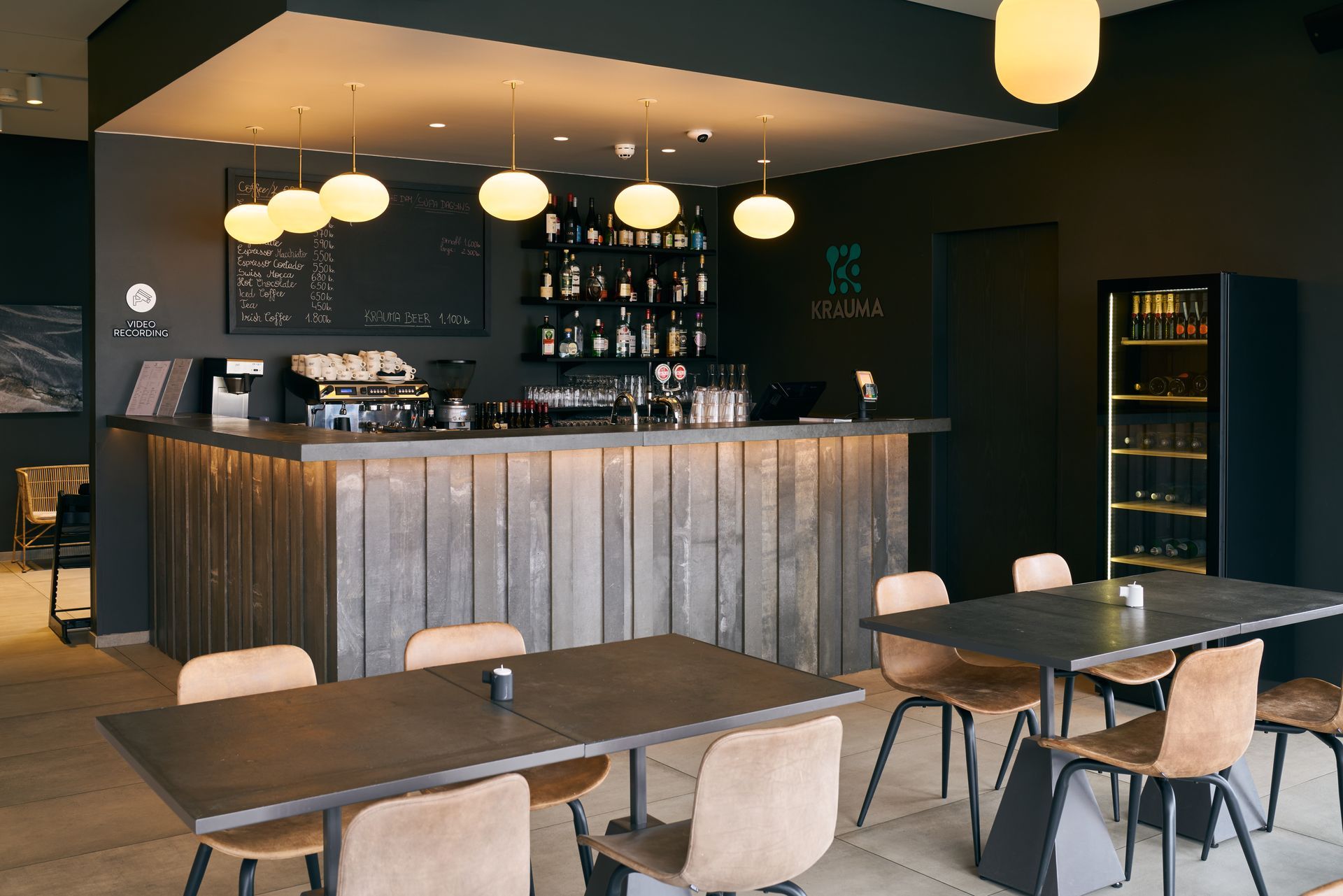 a restaurant with tables and chairs and a bar at Krauma Geothermal