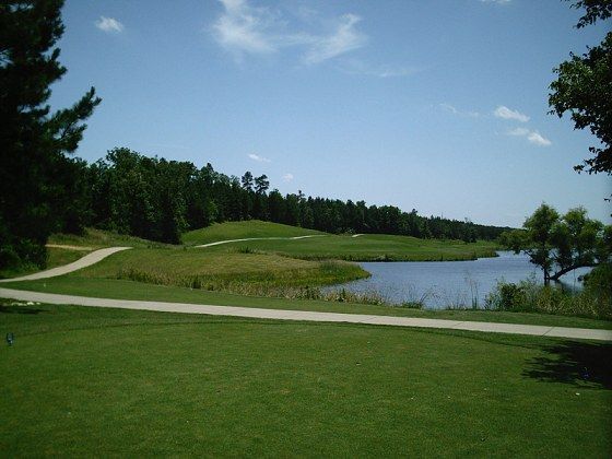 A golf course with a lake in the background