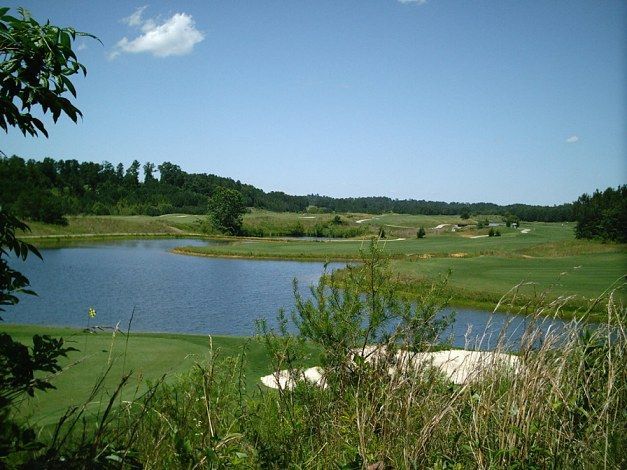 A golf course with a lake in the middle of it