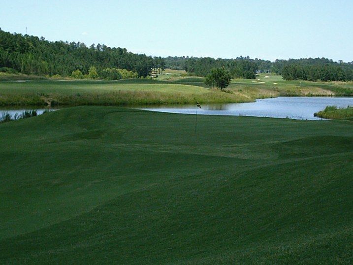 A golf course with a lake in the middle of it