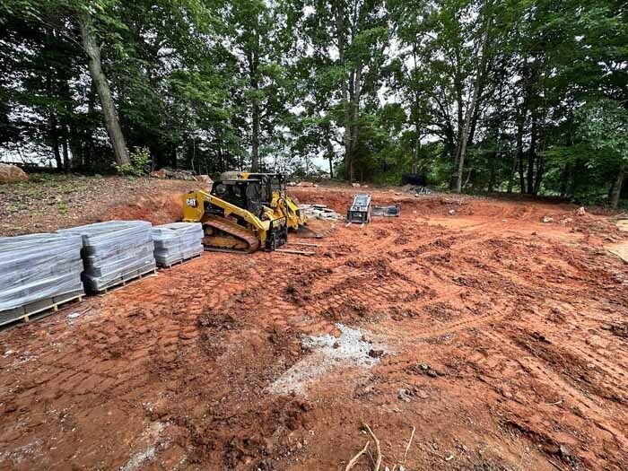 Grading a backyard before installation of a house pad