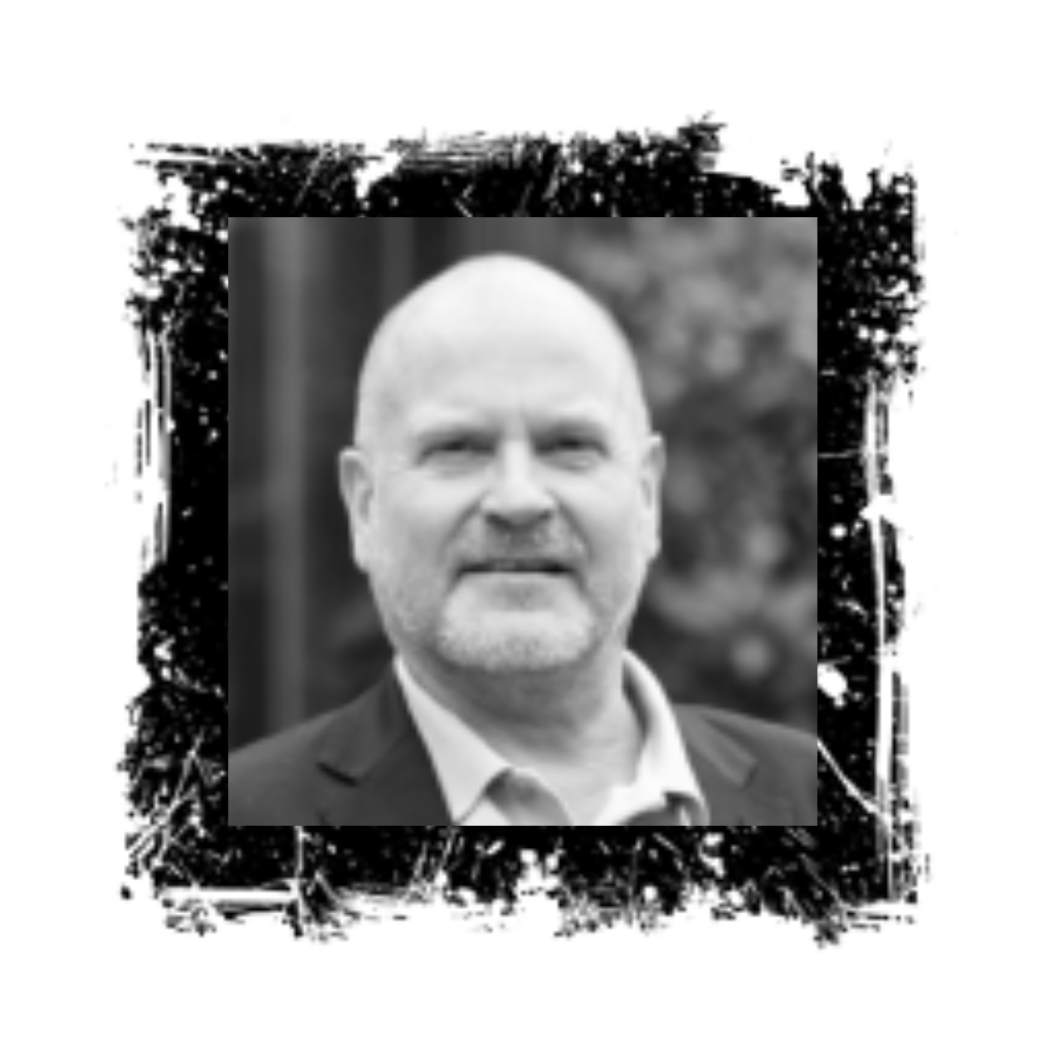 Bald man with a beard in a black suit framed by a messy black and white square.