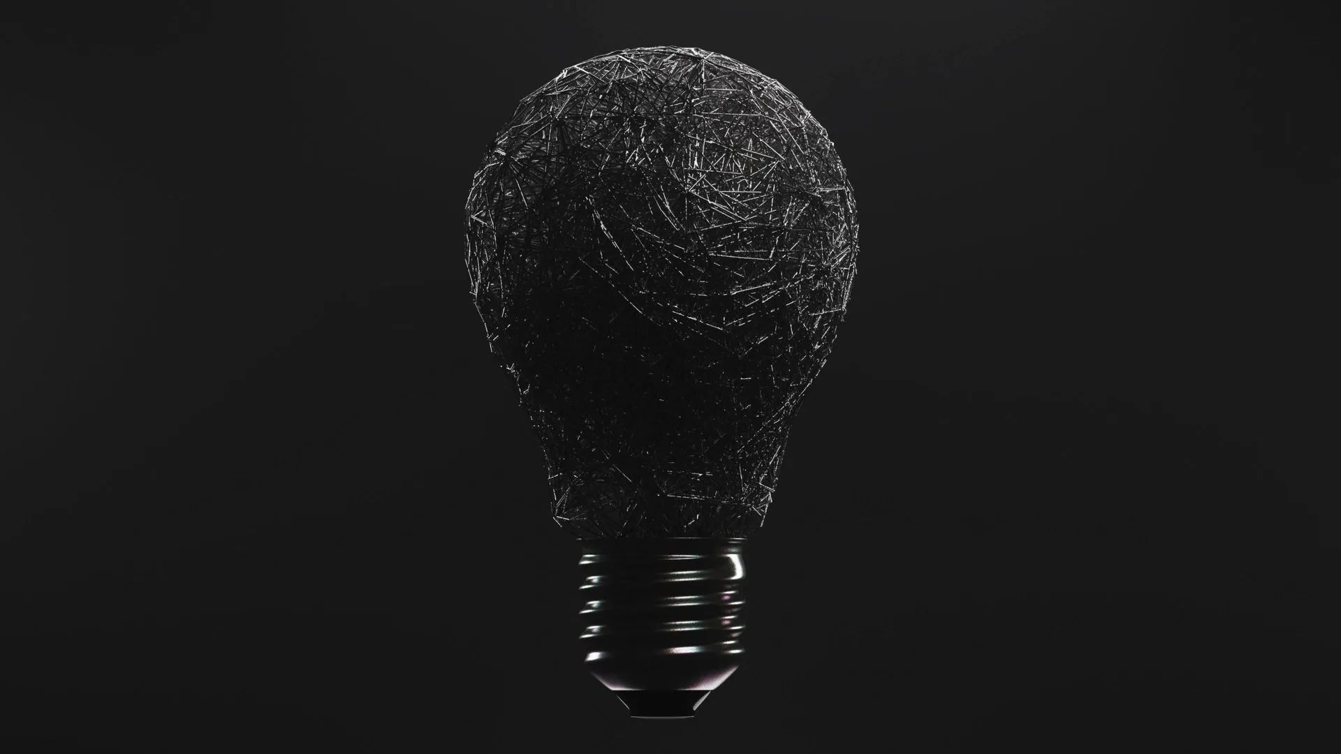 Dark, textured light bulb glowing faintly against a black background