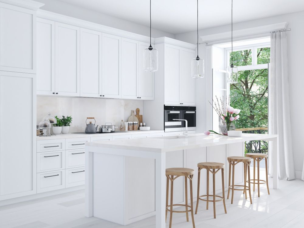A Kitchen with White Cabinets and Stools and A Large Island — Rodney Lees Cabinetmaking In Lismore, NSW