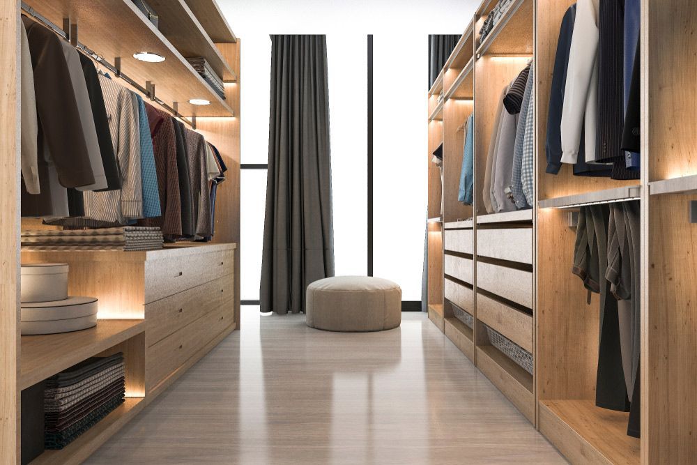 A Walk in Closet Filled with Lots of Clothes and A Window — Rodney Lees Cabinetmaking In Evans Head, NSW