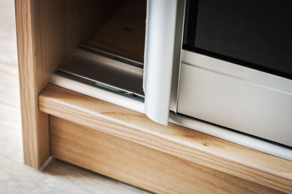 A Close up Of a Sliding Glass Door on A Wooden Cabinet — Rodney Lees Cabinetmaking In Lismore, NSW