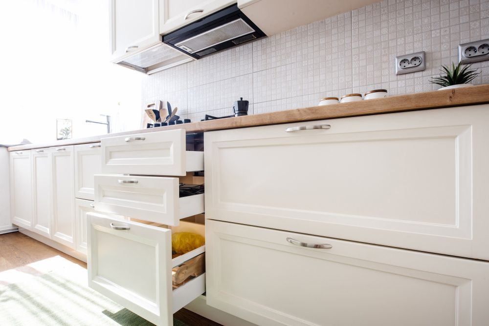 A Kitchen with White Cabinets and Drawers and A Wooden Counter Top — Rodney Lees Cabinetmaking In Lismore, NSW