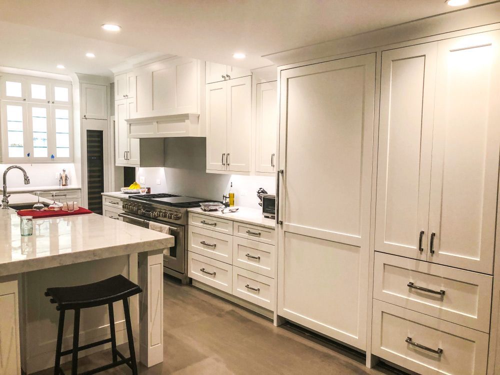 A Kitchen with White Cabinets, Stainless Steel Appliances, and A Large Island — Rodney Lees Cabinetmaking In Ballina, NSW