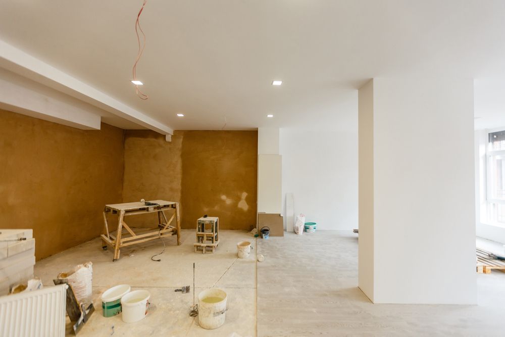 An Empty Room with A Table and Buckets of Paint — Rodney Lees Cabinetmaking In Ballina, NSW