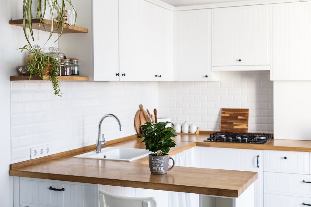 A Kitchen with White Cabinets and A Wooden Counter Top — Rodney Lees Cabinetmaking In Casino, NSW