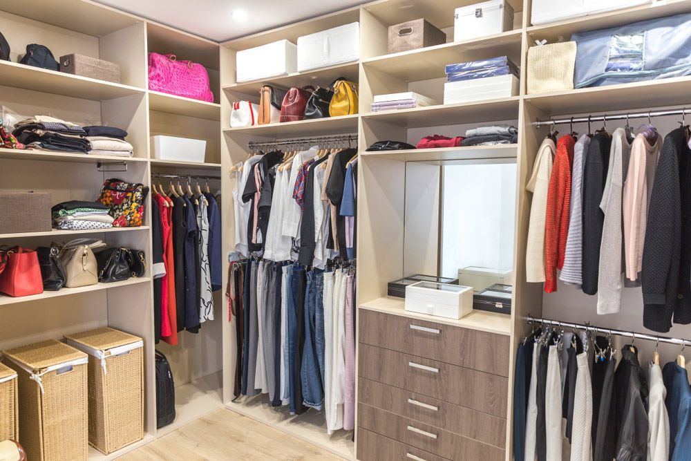 A Walk in Closet Filled with Lots of Clothes and Bags — Rodney Lees Cabinetmaking In Mullumbimby, NSW