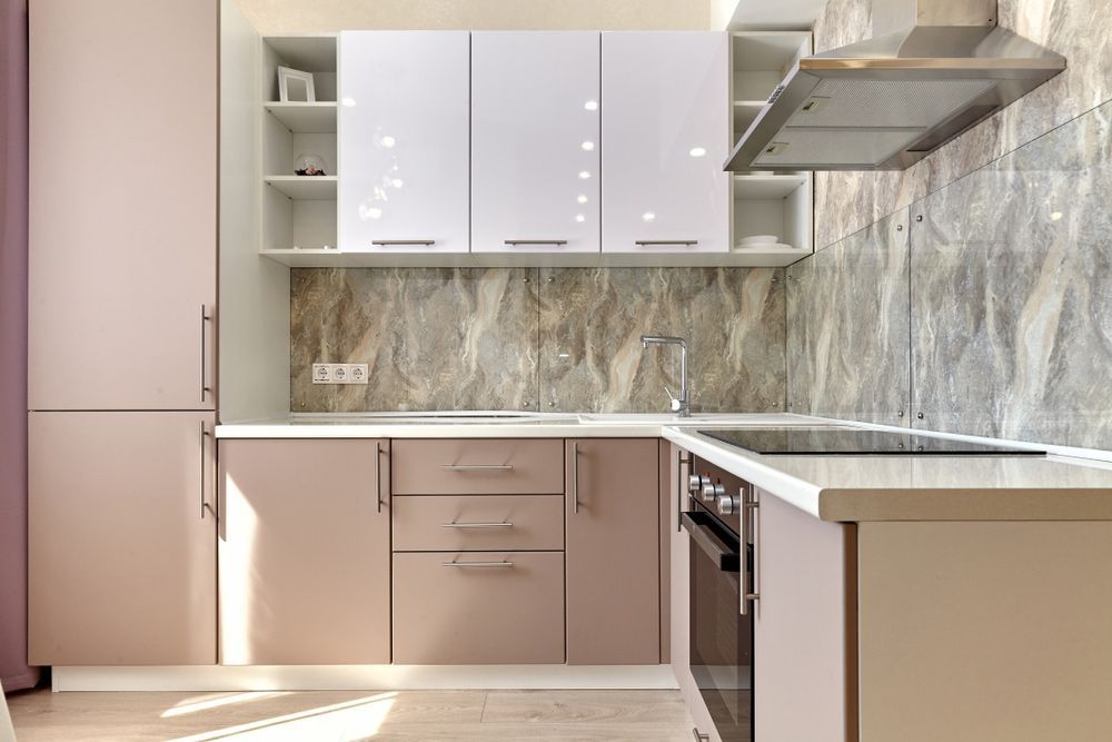 A Kitchen with White Cabinets, a Stove, a Sink, and A Hood — Rodney Lees Cabinetmaking In Monaltrie, NSW