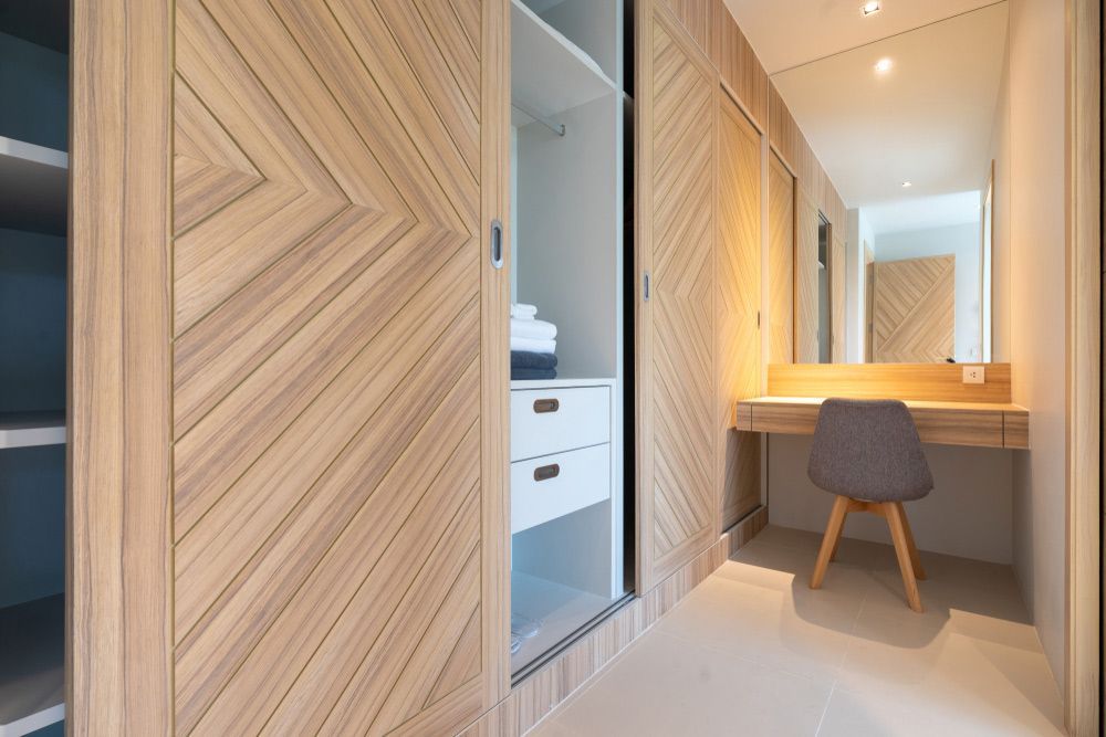 A Walk in Closet with Sliding Doors, a Desk, a Chair and A Mirror — Rodney Lees Cabinetmaking In Ocean Shores, NSW