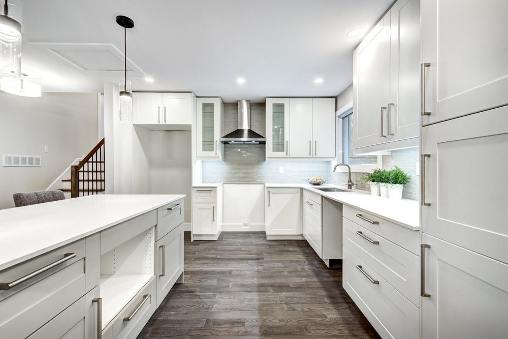 A Kitchen with White Cabinets and Stainless Steel Appliances — Rodney Lees Cabinetmaking In Monaltrie, NSW
