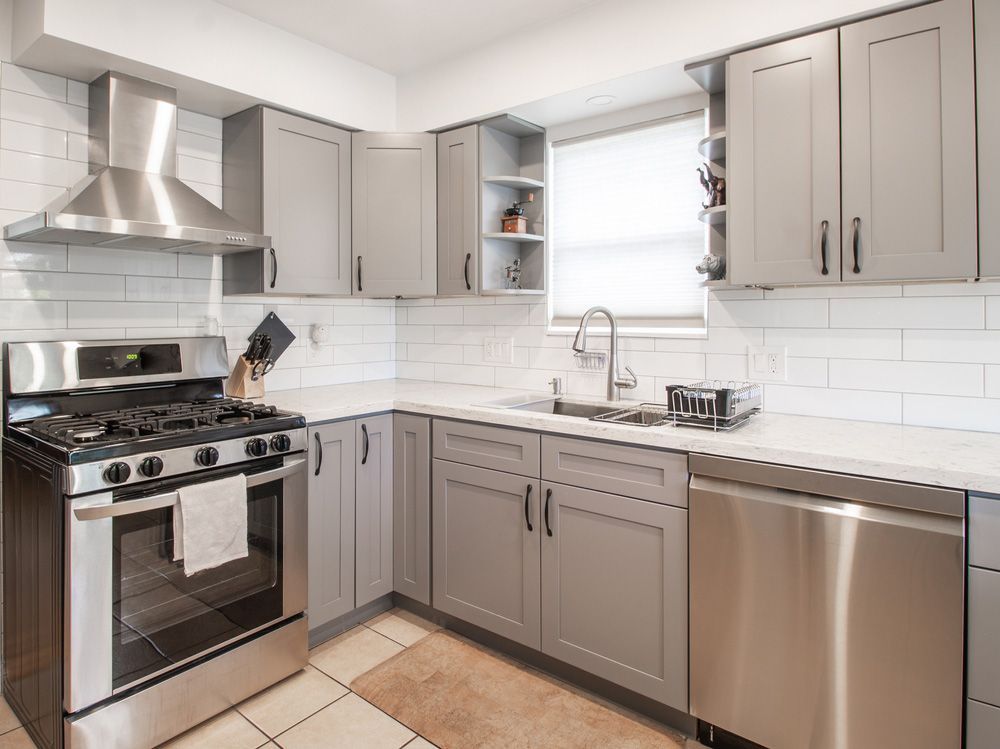 A Kitchen with Stainless Steel Appliances and Gray Cabinets — Rodney Lees Cabinetmaking In Monaltrie, NSW