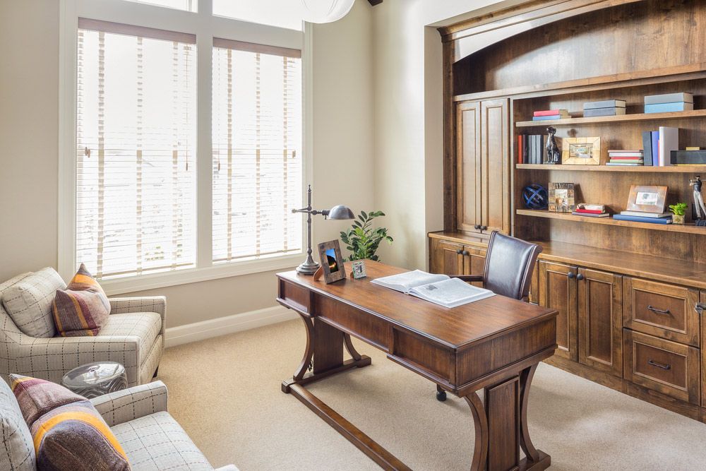A Home Office with A Wooden Desk, Chairs, Shelves and A Couch — Rodney Lees Cabinetmaking In Lismore, NSW