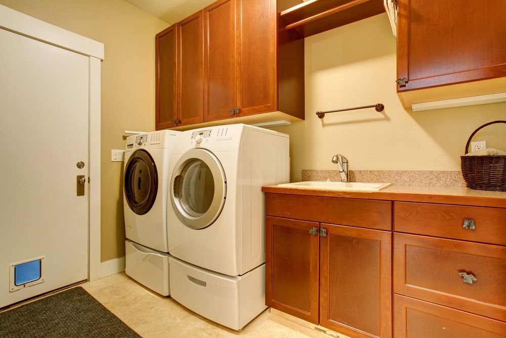 A Laundry Room with A Washer and Dryer and A Sink — Rodney Lees Cabinetmaking In Ocean Shores, NSW