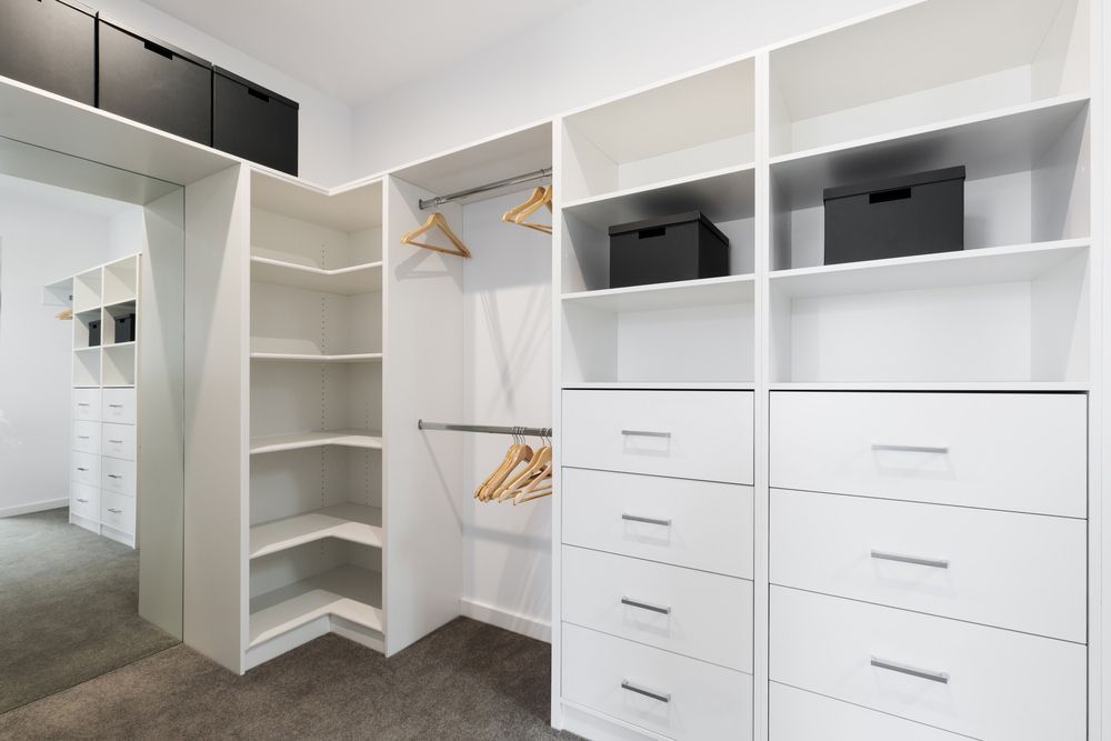 A Walk in Closet with White Shelves, Drawers, and A Mirror — Rodney Lees Cabinetmaking In Casino, NSW