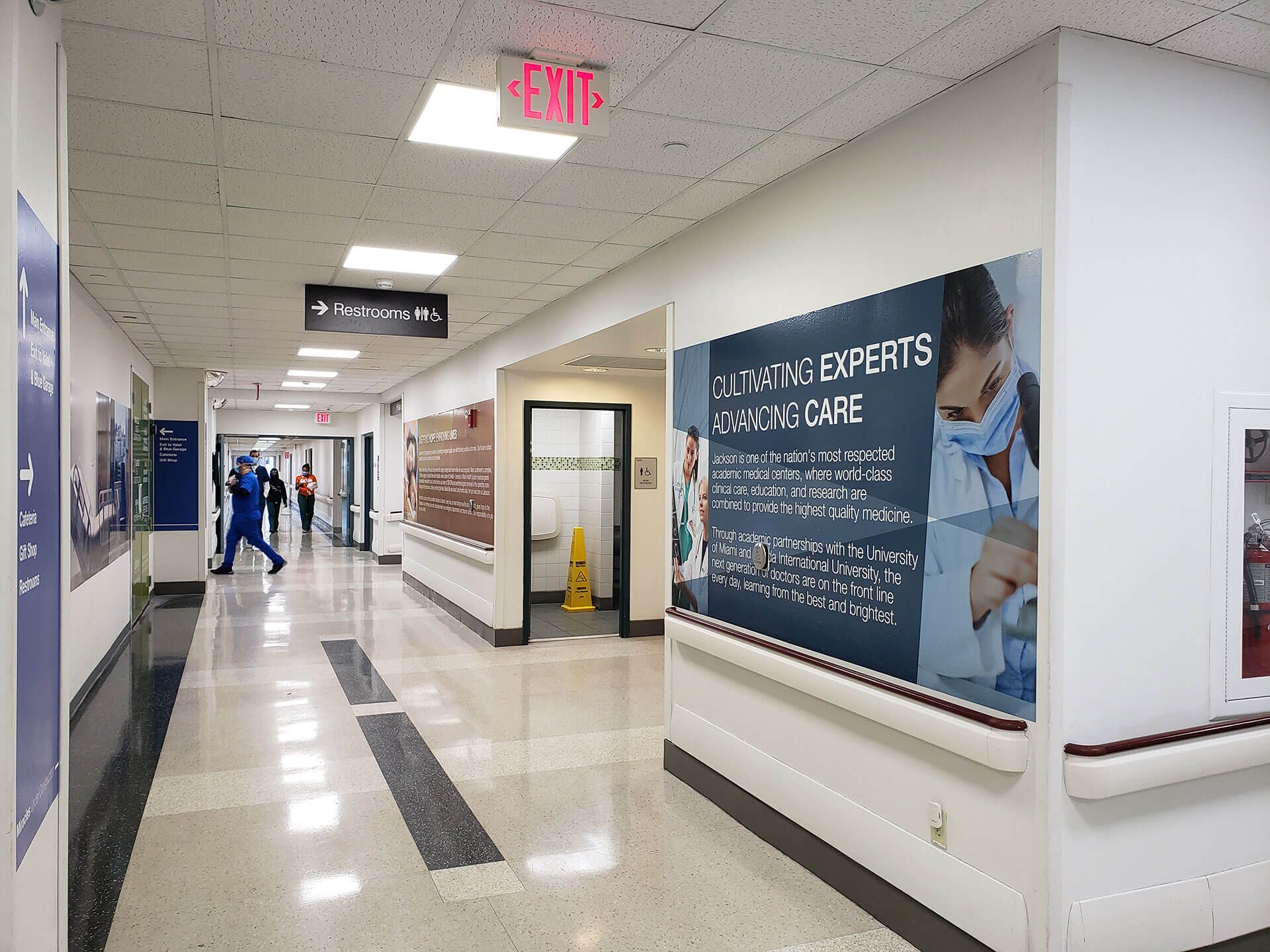 A hospital hallway with a sign on the wall that says advanced care