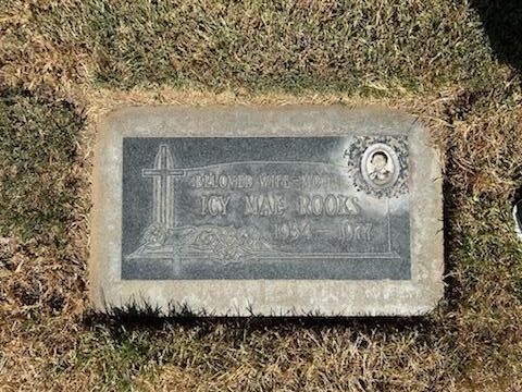 Headstone with etched cross and text: 