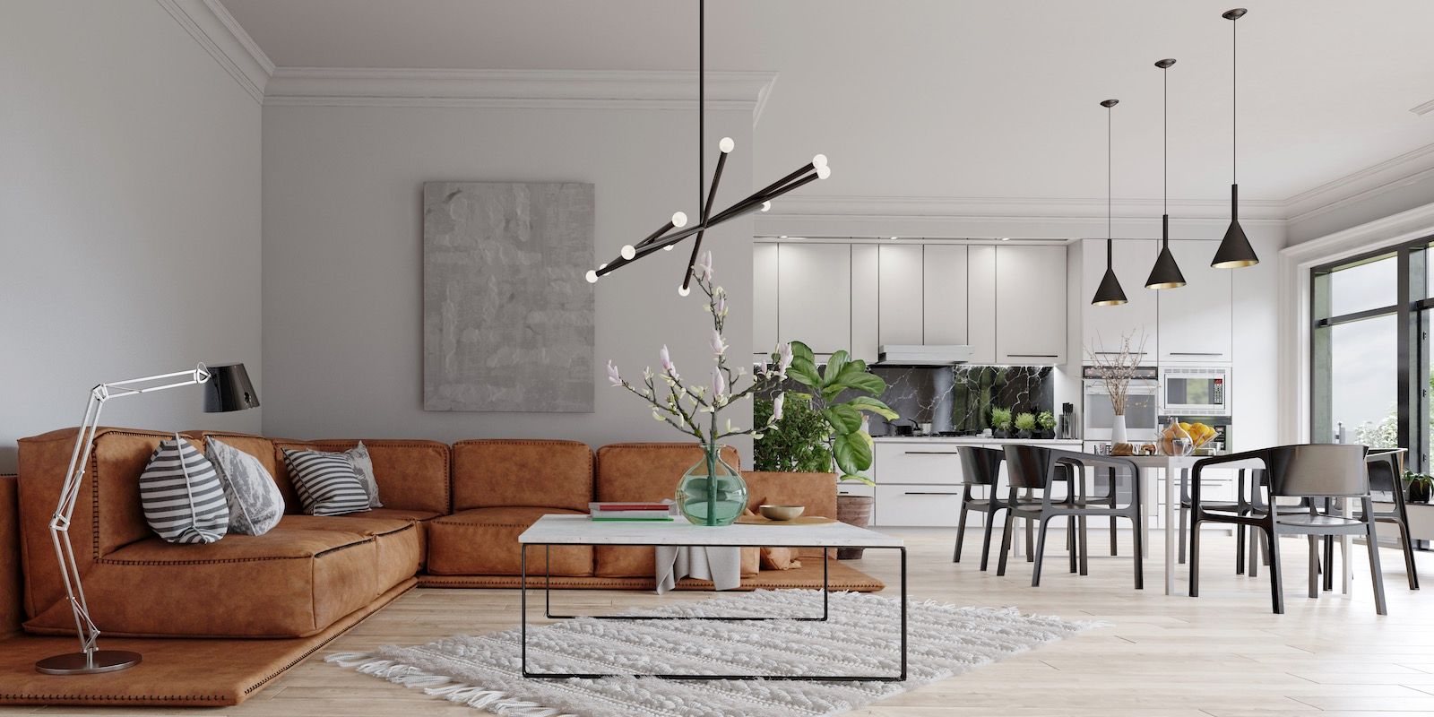 Modern living room with brown sectional, white kitchen, and dining area, light wood floors, and large windows.