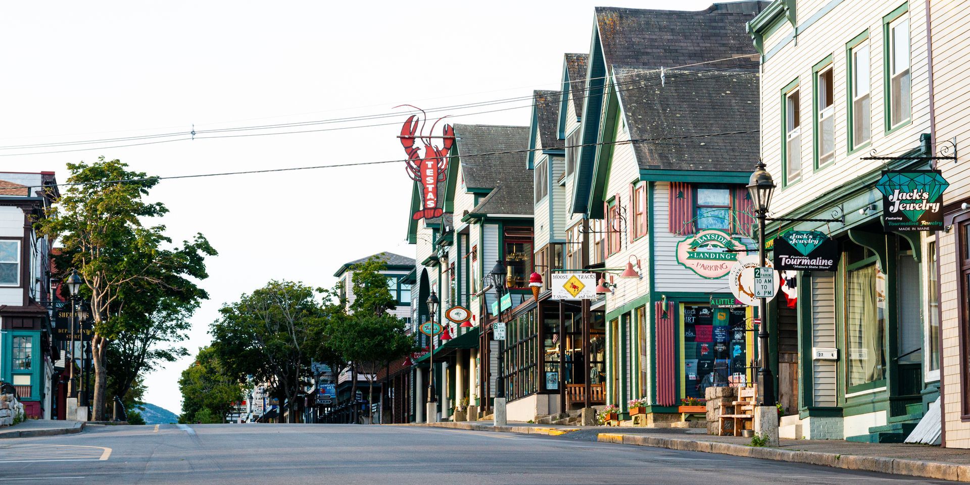 Street lined with shops and restaurants in a coastal town