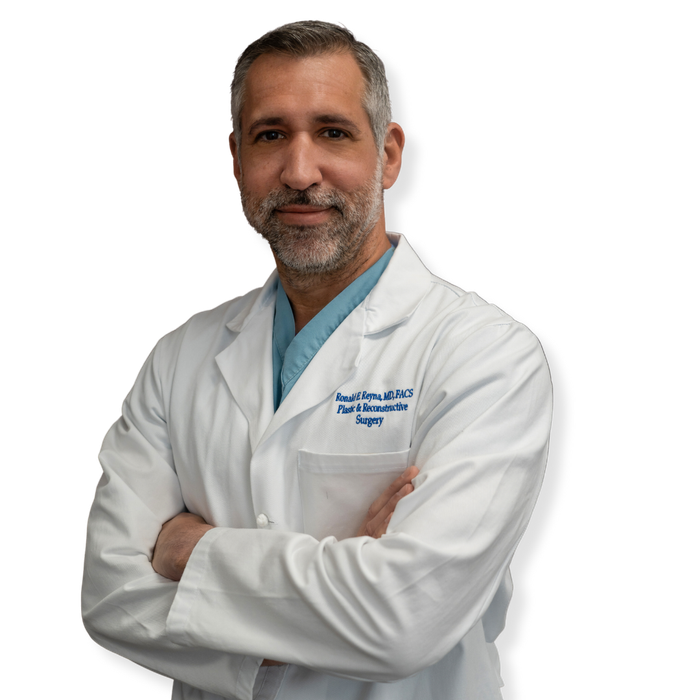 A man in a white lab coat with the word surgery on his chest