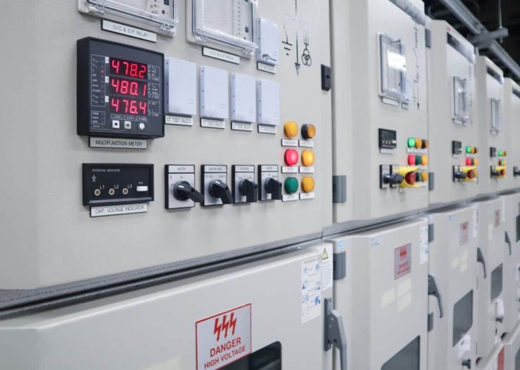A Row Of Electrical Panels With A Lot Of Buttons And Switches On Them — Mozzlec Electrical & Airconditioning In Urangan, QLD