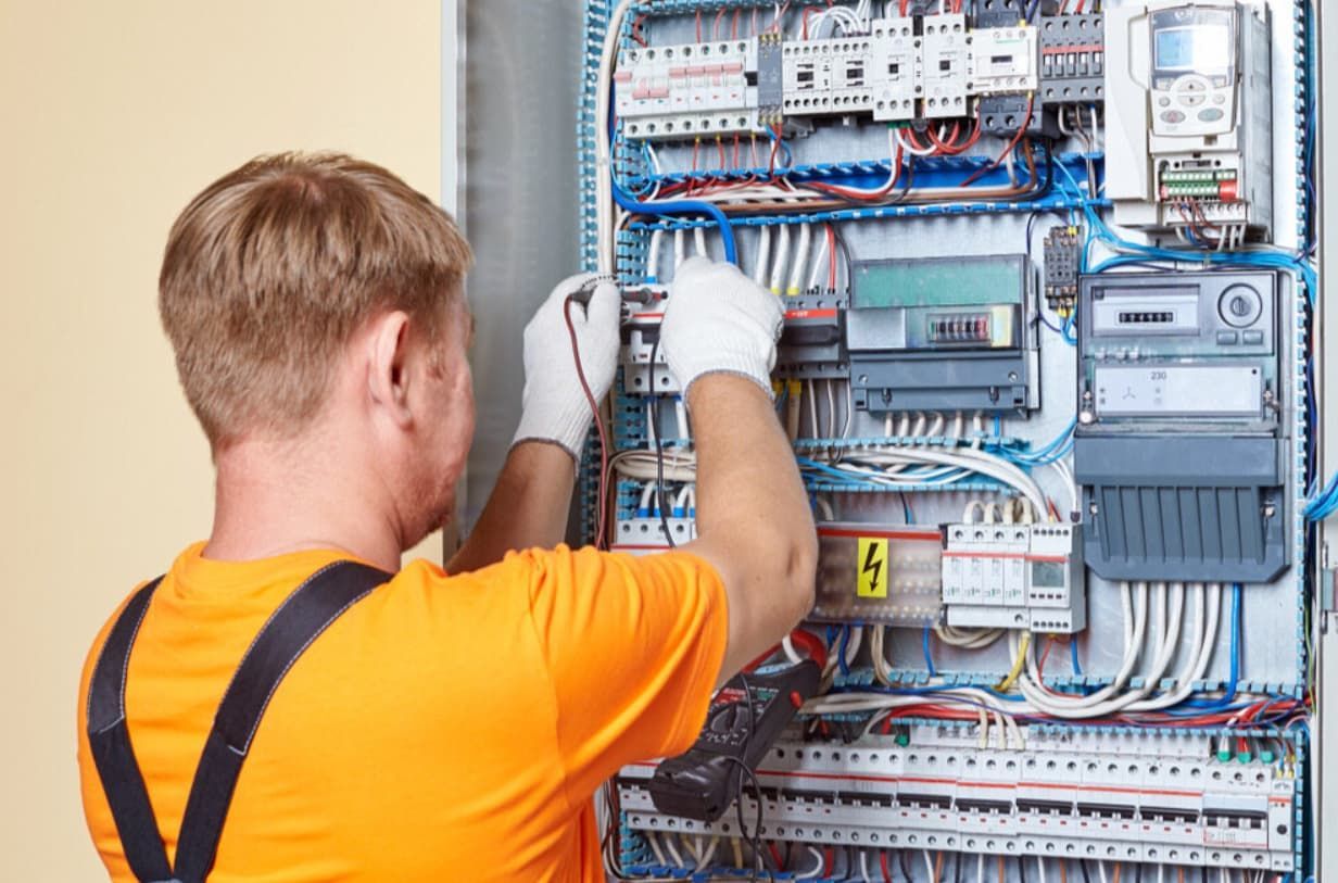An Electrician Is Working On An Electrical Panel — Mozzlec Electrical & Airconditioning In Urangan, QLD