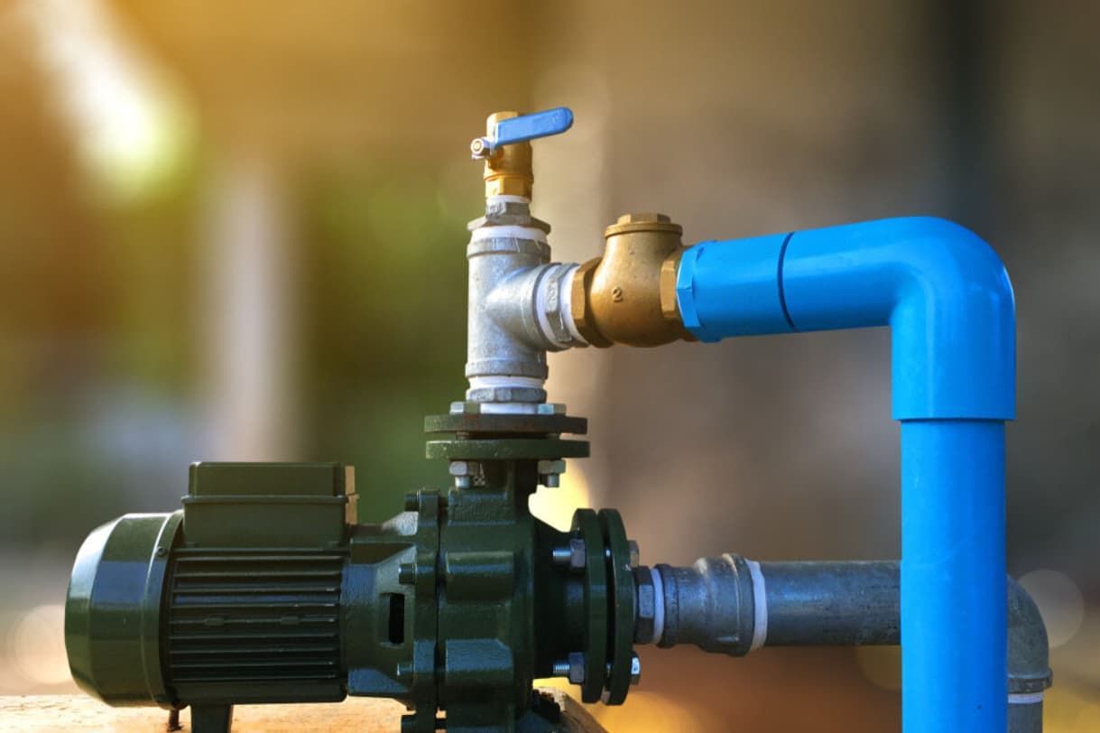 A Close Up Of A Water Pump With A Blue Pipe Attached To It — Mozzlec Electrical & Airconditioning In Urangan, QLD