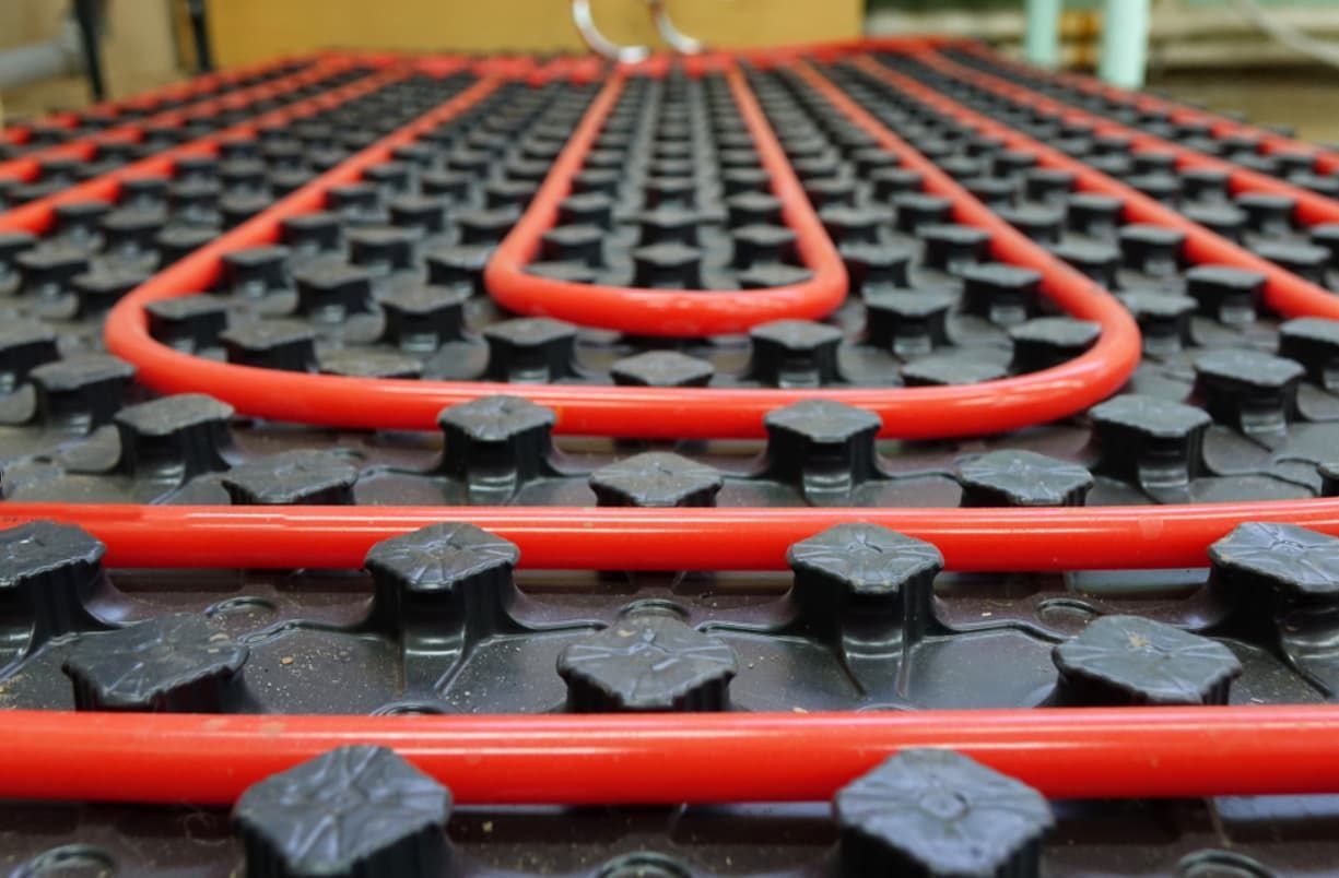A Close Up Of A Red And Black Underfloor Heating System — Mozzlec Electrical & Airconditioning In Urangan, QLD