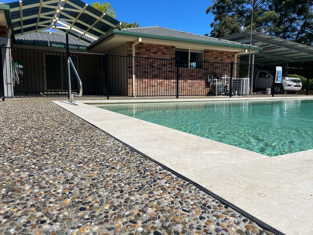 A House With A Swimming Pool In Front Of It  — Brodie Wynter Concreting in Dubbo, NSW