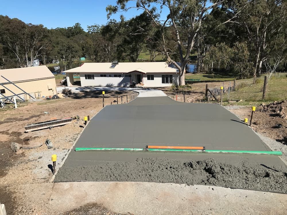 A Concrete Driveway Is Being Built In Front Of A House  — Brodie Wynter Concreting in Port Macquarie, NSW