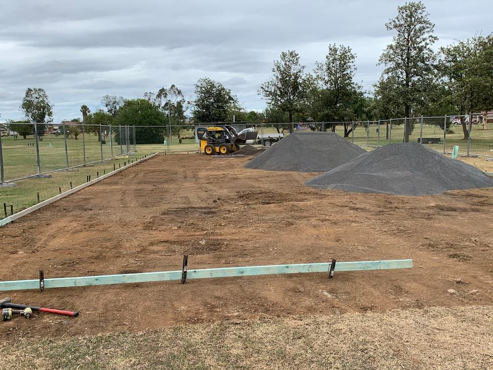 A Large Pile Of Dirt Is Sitting In The Middle Of A Dirt Field  — Brodie Wynter Concreting in Port Macquarie, NSW