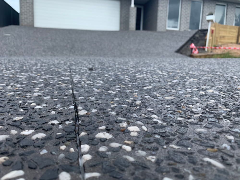 A Close Up Of A Concrete Driveway In Front Of A House  — Brodie Wynter Concreting in Harrington, NSW