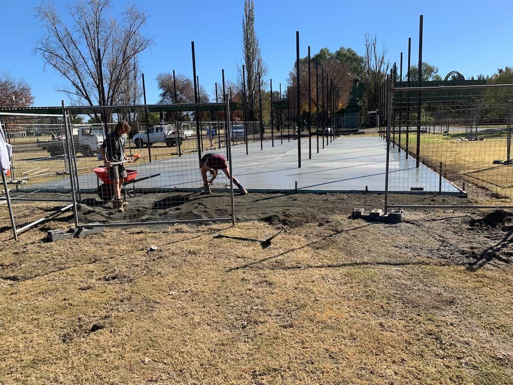 A Man Is Working On A Concrete Floor In A Field  — Brodie Wynter Concreting in Dubbo, NSW