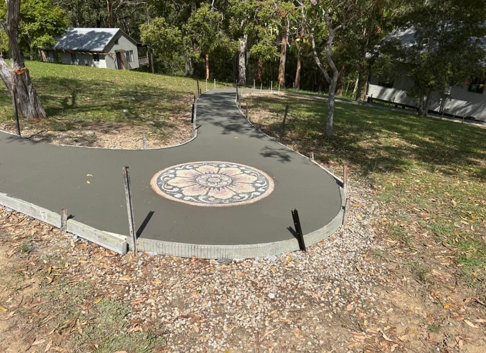 A Concrete Walkway With A Mosaic Design On It In A Park  — Brodie Wynter Concreting in Port Macquarie, NSW