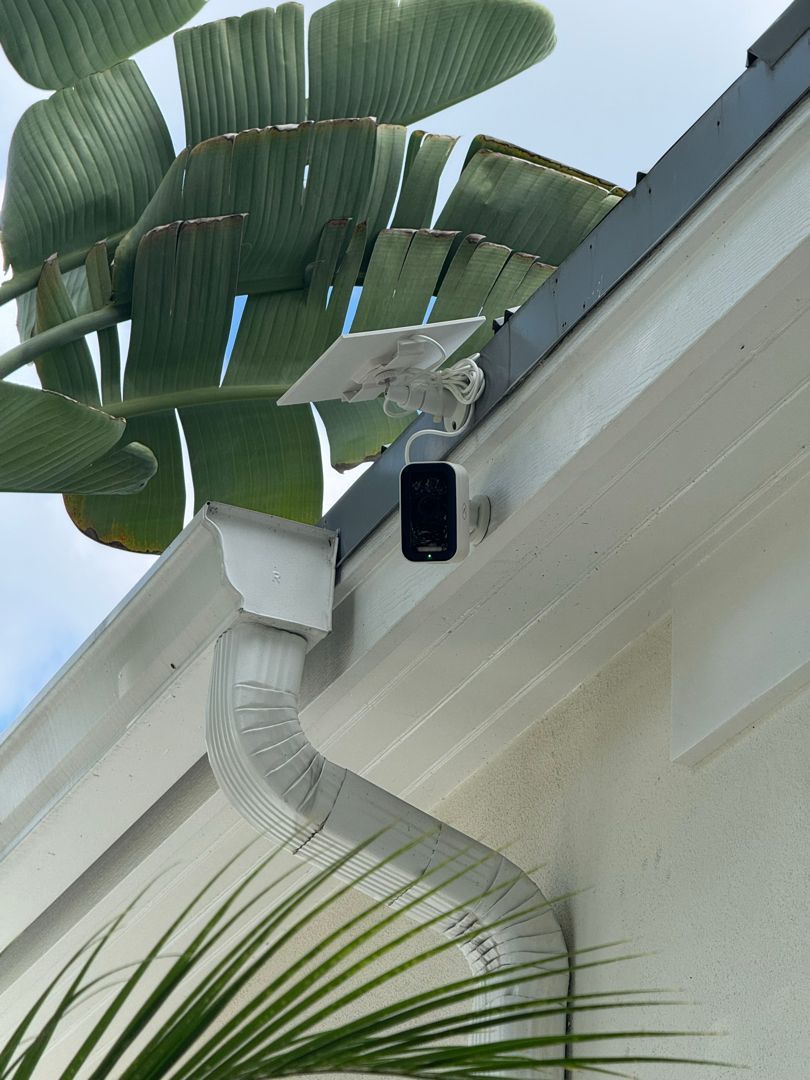 Solar-powered security camera mounted on the front of a Sarasota home
