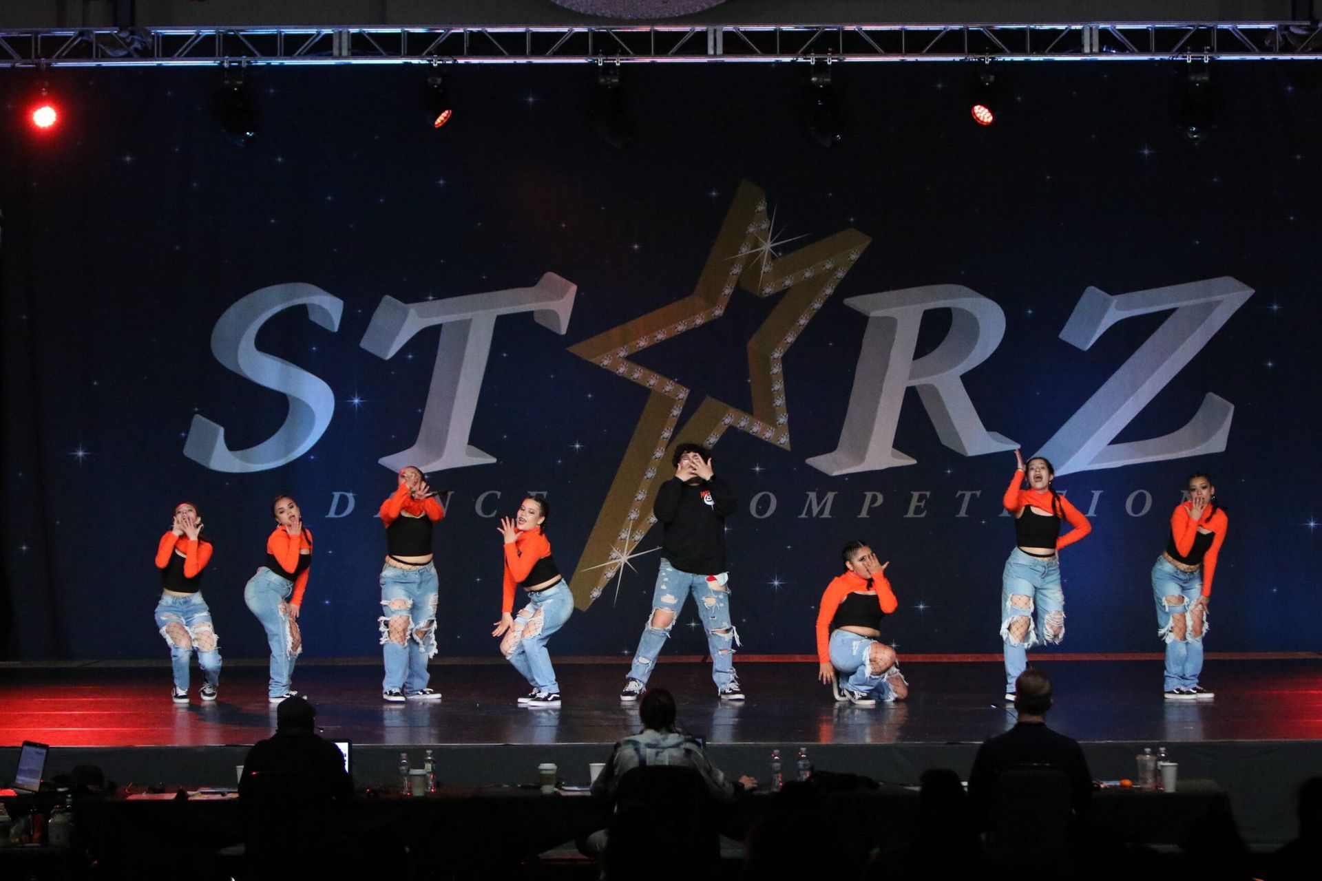 A group of dancers are performing in front of a starz logo