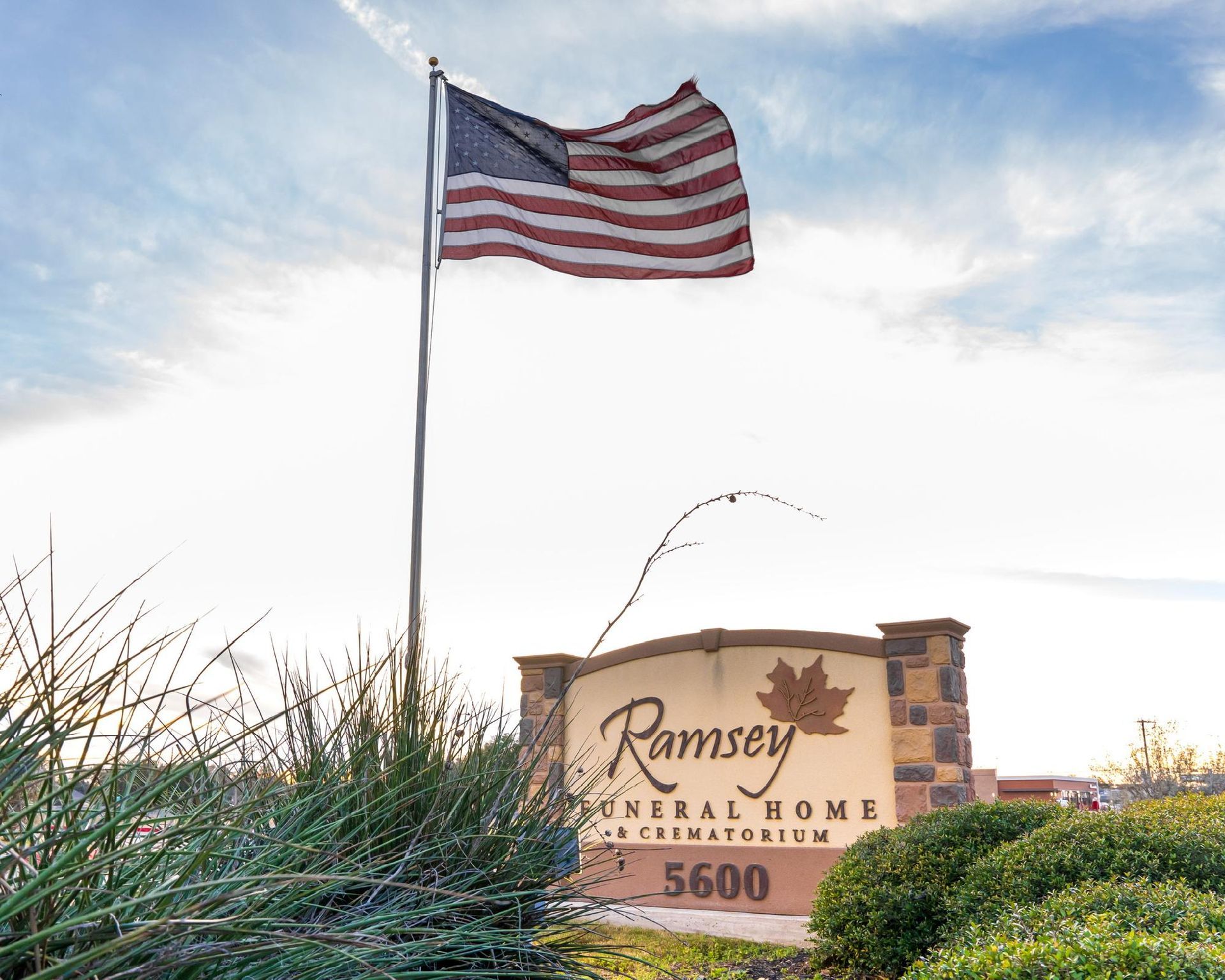 American flag over Ramsey Funeral Home sign at 5600.