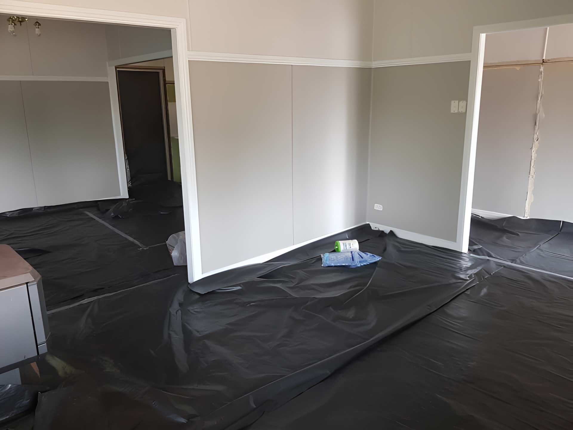 An Empty Room With A Black Tarp On The Floor — Accredited Asbestos Removers in Lismore, NSW