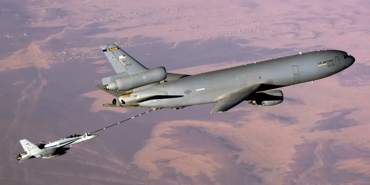 A KC-10 refueling an F/A-18 over the desert