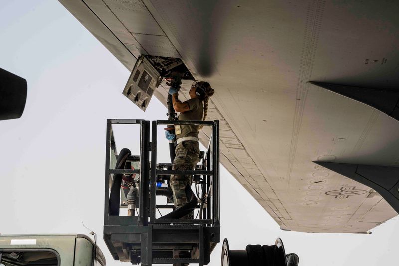 An airman fueling an aircraft from a lift on the flightline