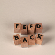 Wooden blocks arranged in two rows spell out the word 