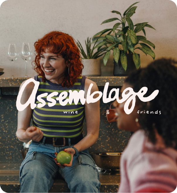 Two people in a modern kitchen with the word “Assemblage” overlaid in white script.