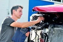 Car mechanic checking the engine