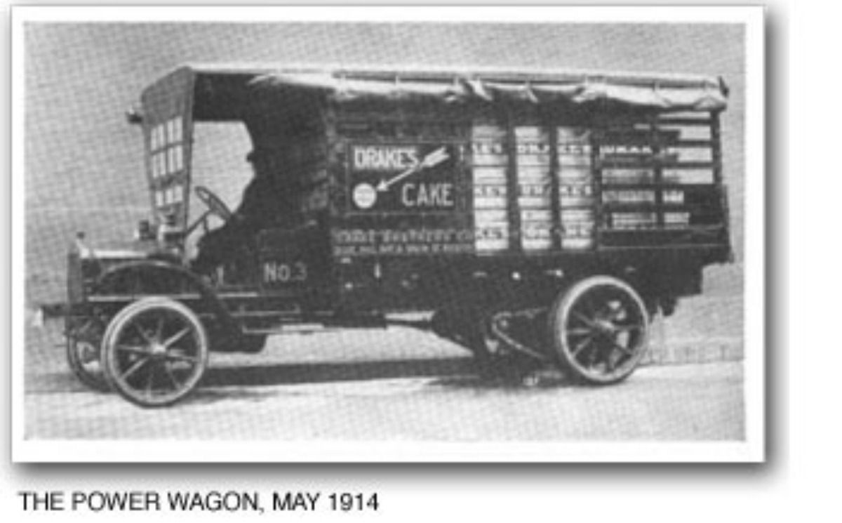 A 1914 Drake’s Cake delivery truck with wooden-spoke wheels and an open-sided cargo bed.